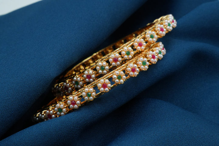 Elegant Gold Bangles Adorned with White Pearl Flowers - Victorian Jaipur